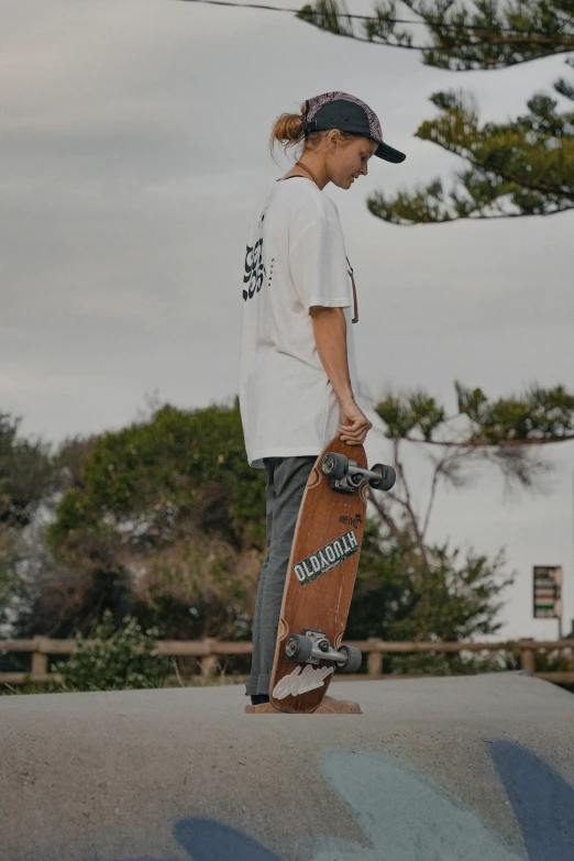 a boy with skateboard in his hands riding a ramp