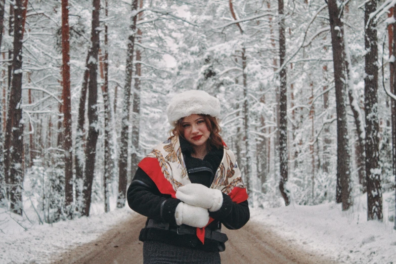 woman standing in the snow with hands crossed