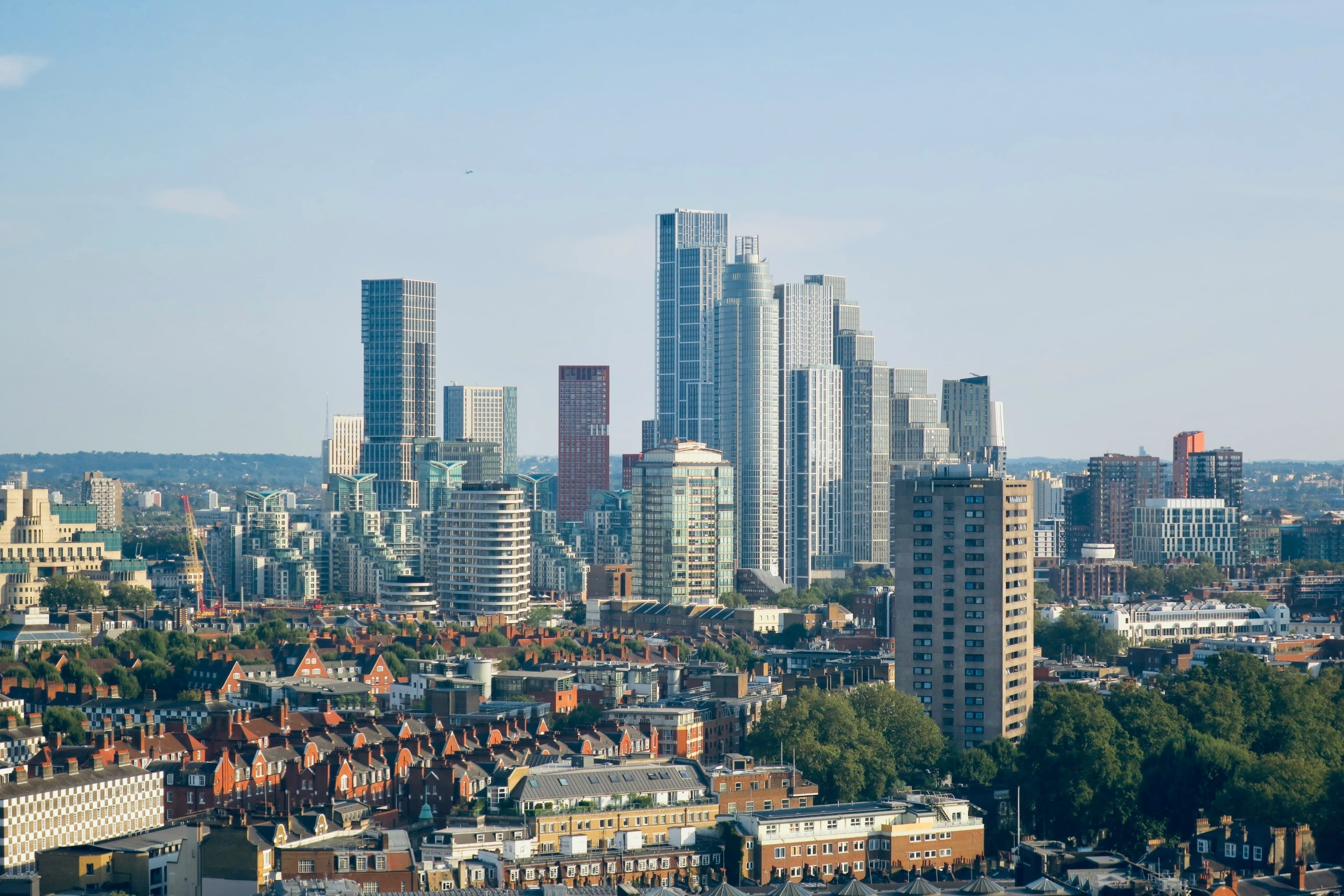 a group of buildings in a city with a lot of trees