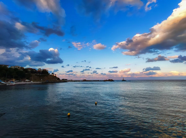 view from the shore of a bay at sunset