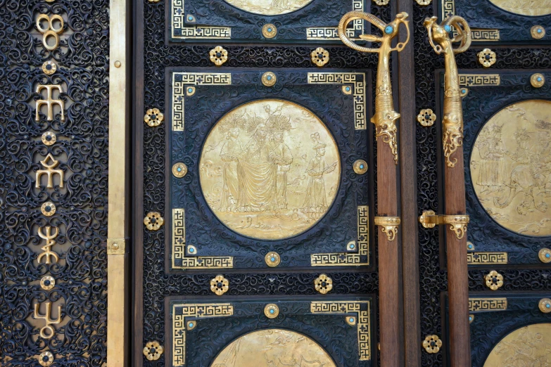 two doors with elaborate carving work and a large ornate key