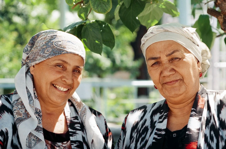 two older women smiling for the camera in their native clothing