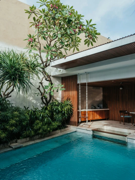 the outside pool features trees and flowers for shade