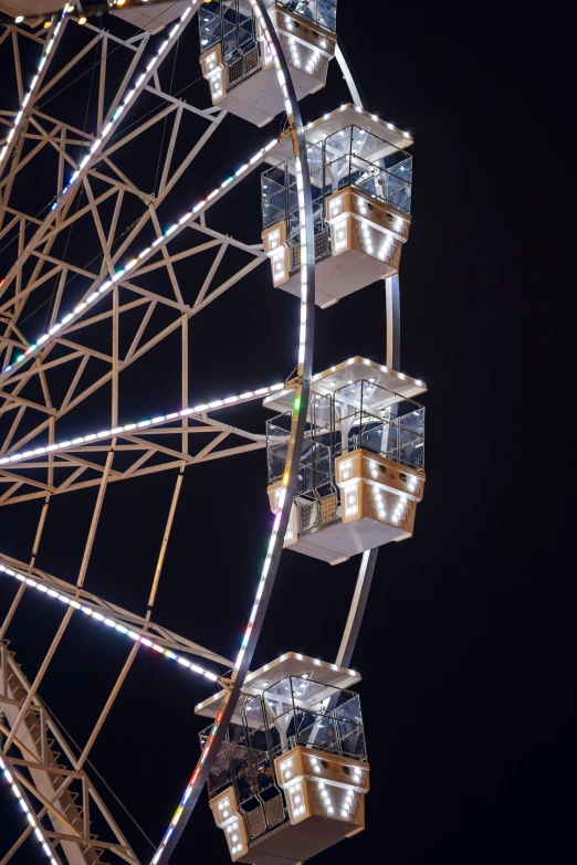 ferris wheel with lit - up windows in a dark sky