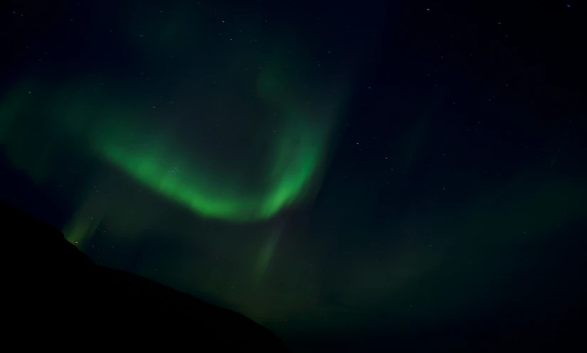 a bright green and blue aurora bore above the earth