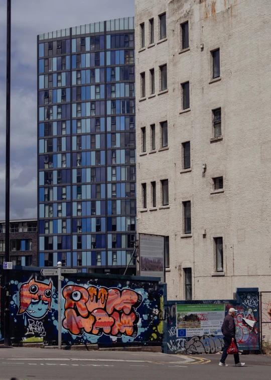 two tall buildings that are decorated in graffiti