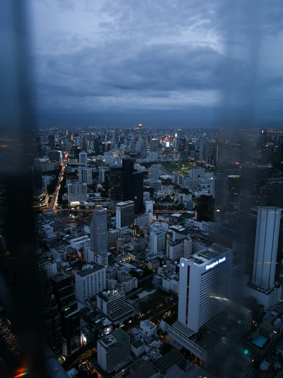 a city filled with tall buildings under a cloudy sky