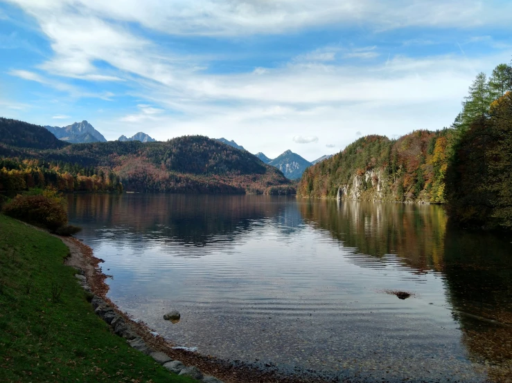 a lake in the middle of some forested hills