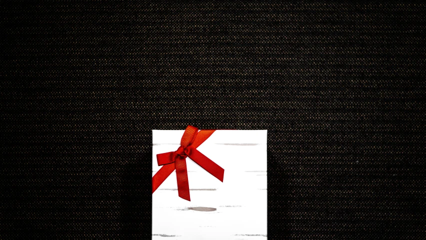 red ribbon on white card with black background