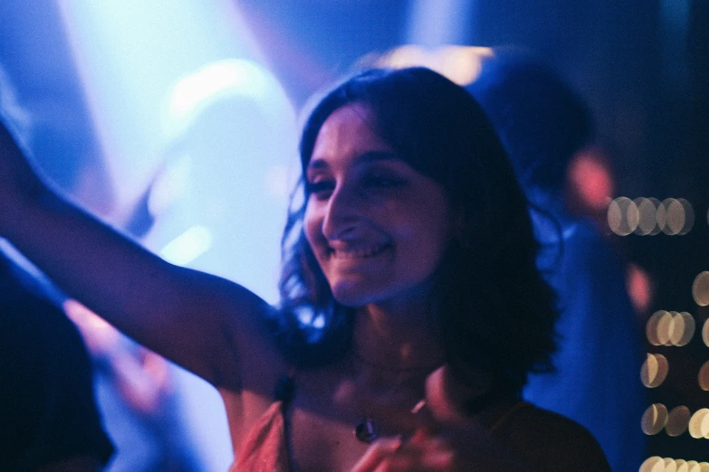 a woman in a black dress dancing at a party