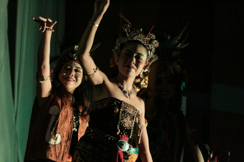 two women with elaborate costumes and beads posing together