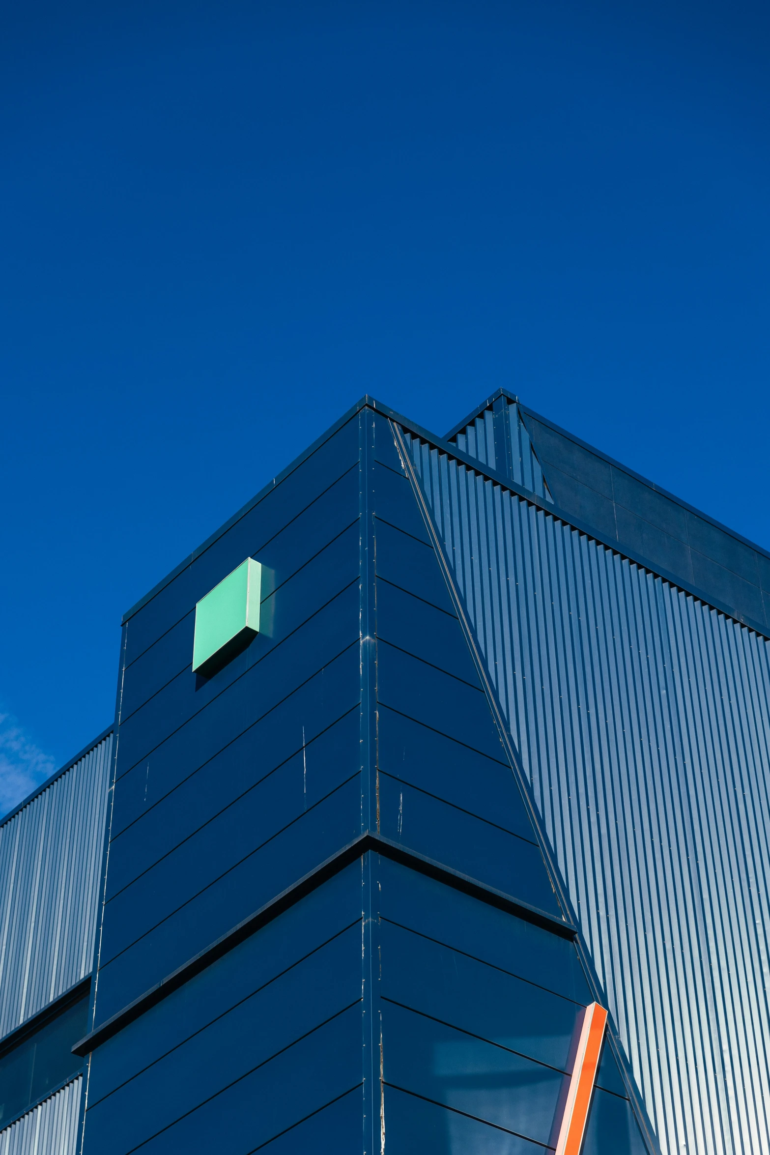 a modern building with many windows and green square