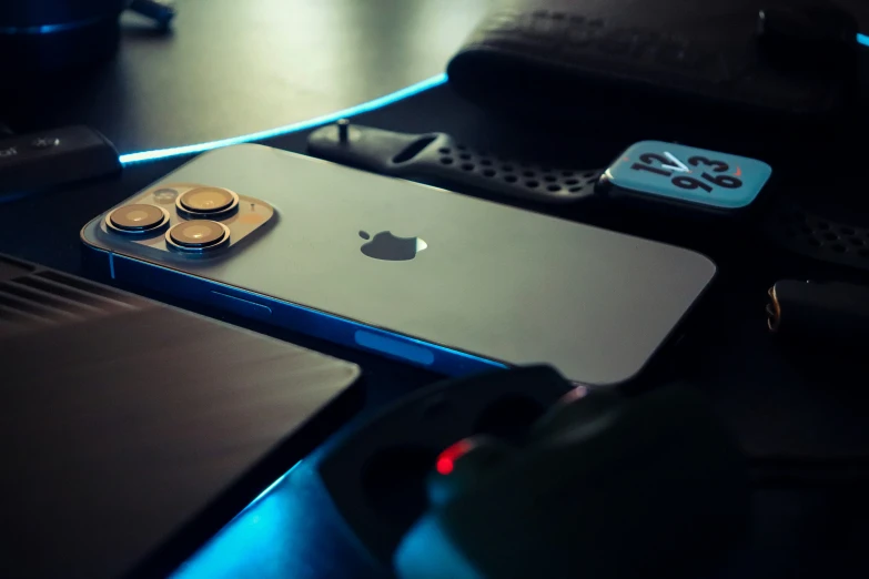 a gold iphone sitting on top of a black table