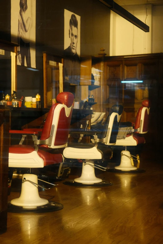 a row of barbers on a wooden floor in a barber shop