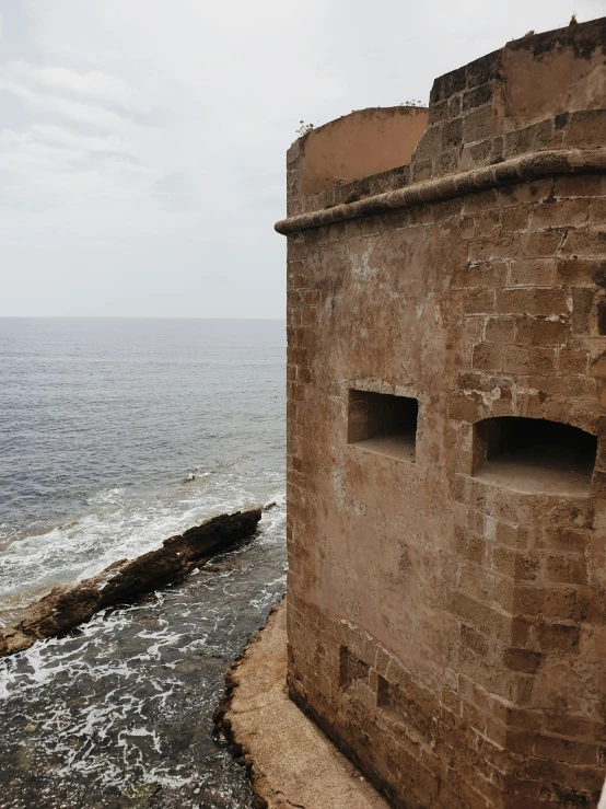 a couple of building with open windows on the water