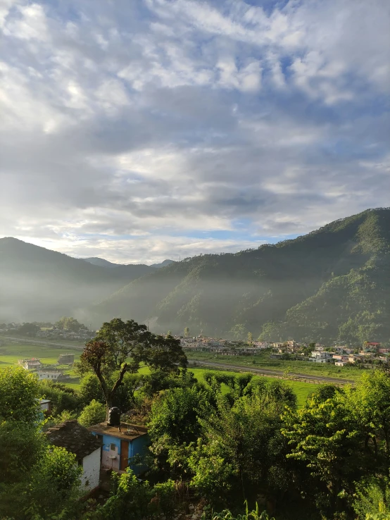 a small village on a hillside with green trees