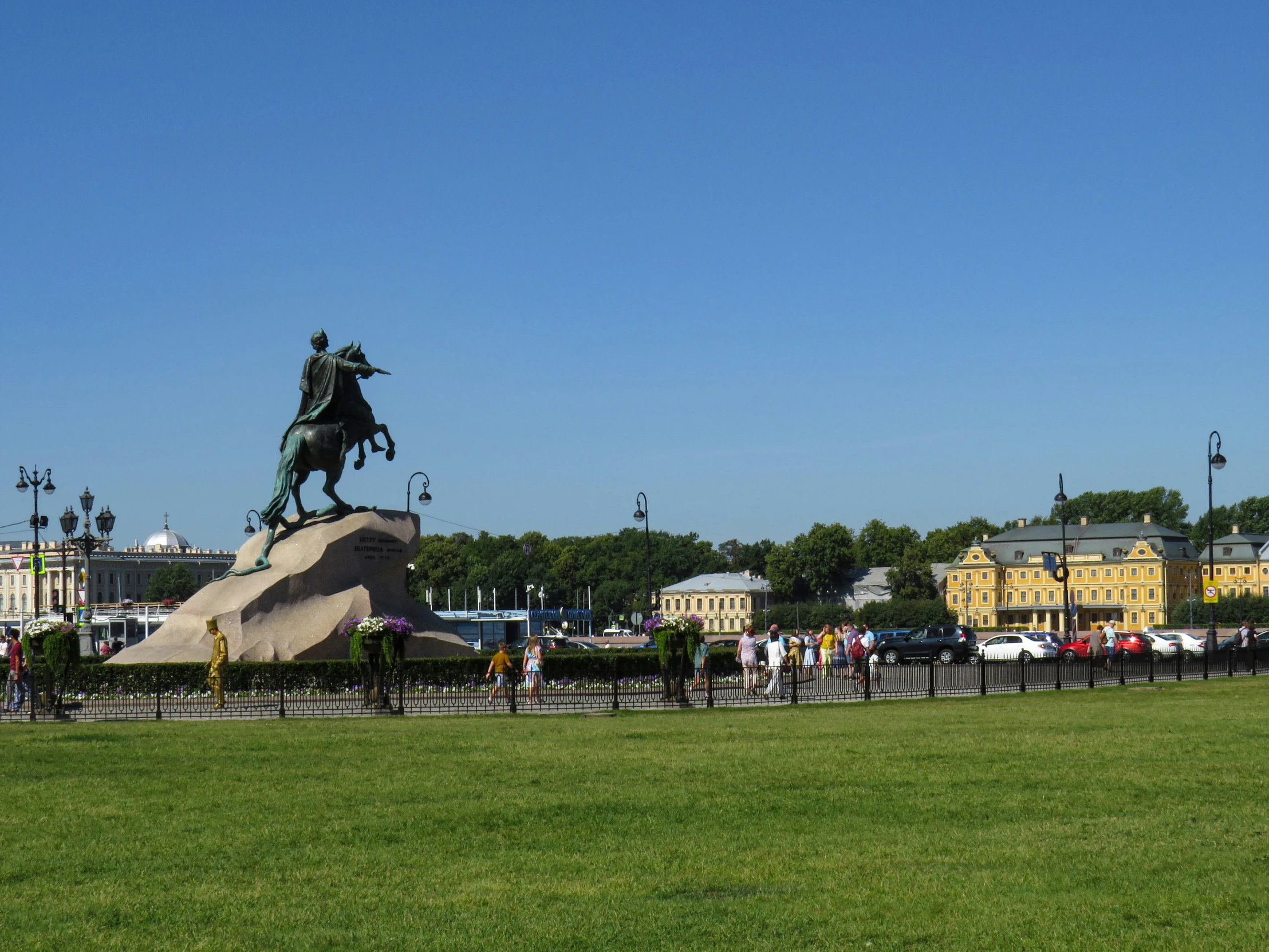 a large crowd is standing near the statue