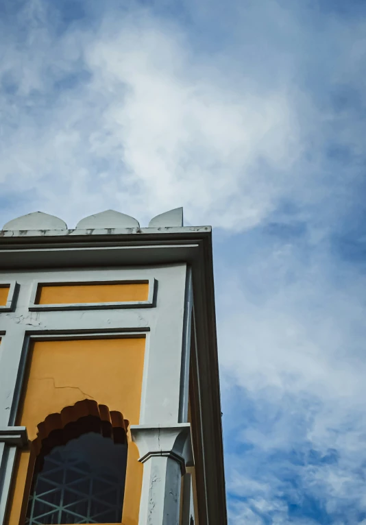 a yellow door is surrounded by white windows