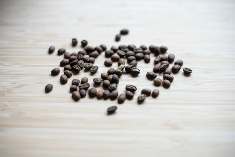 a close up of coffee beans and one broken