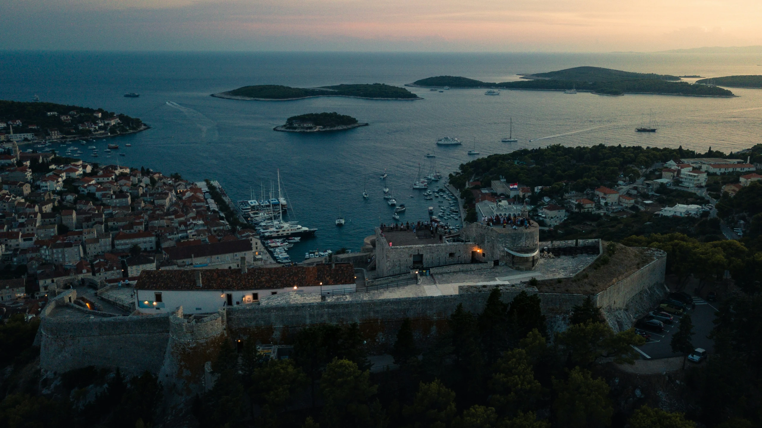 an aerial s shows many boats moored at different marinas