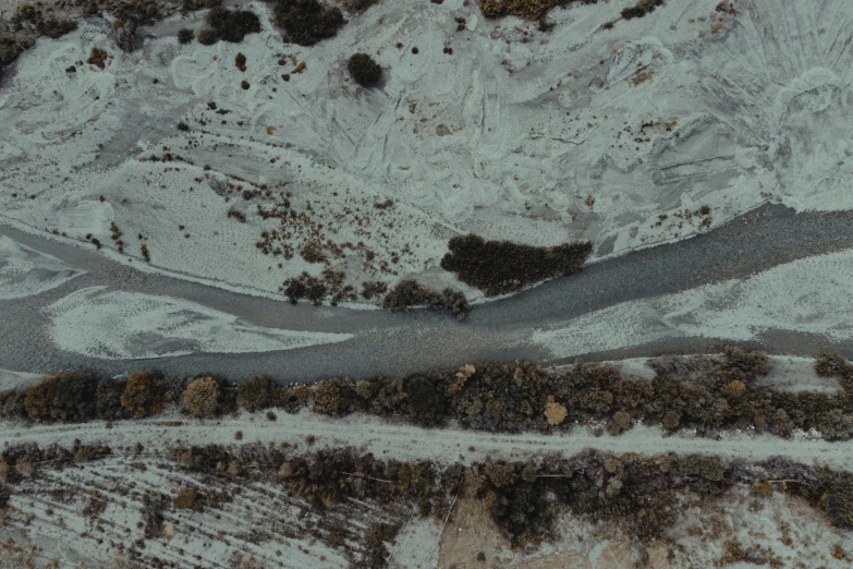 a road runs through the mountains covered with snow