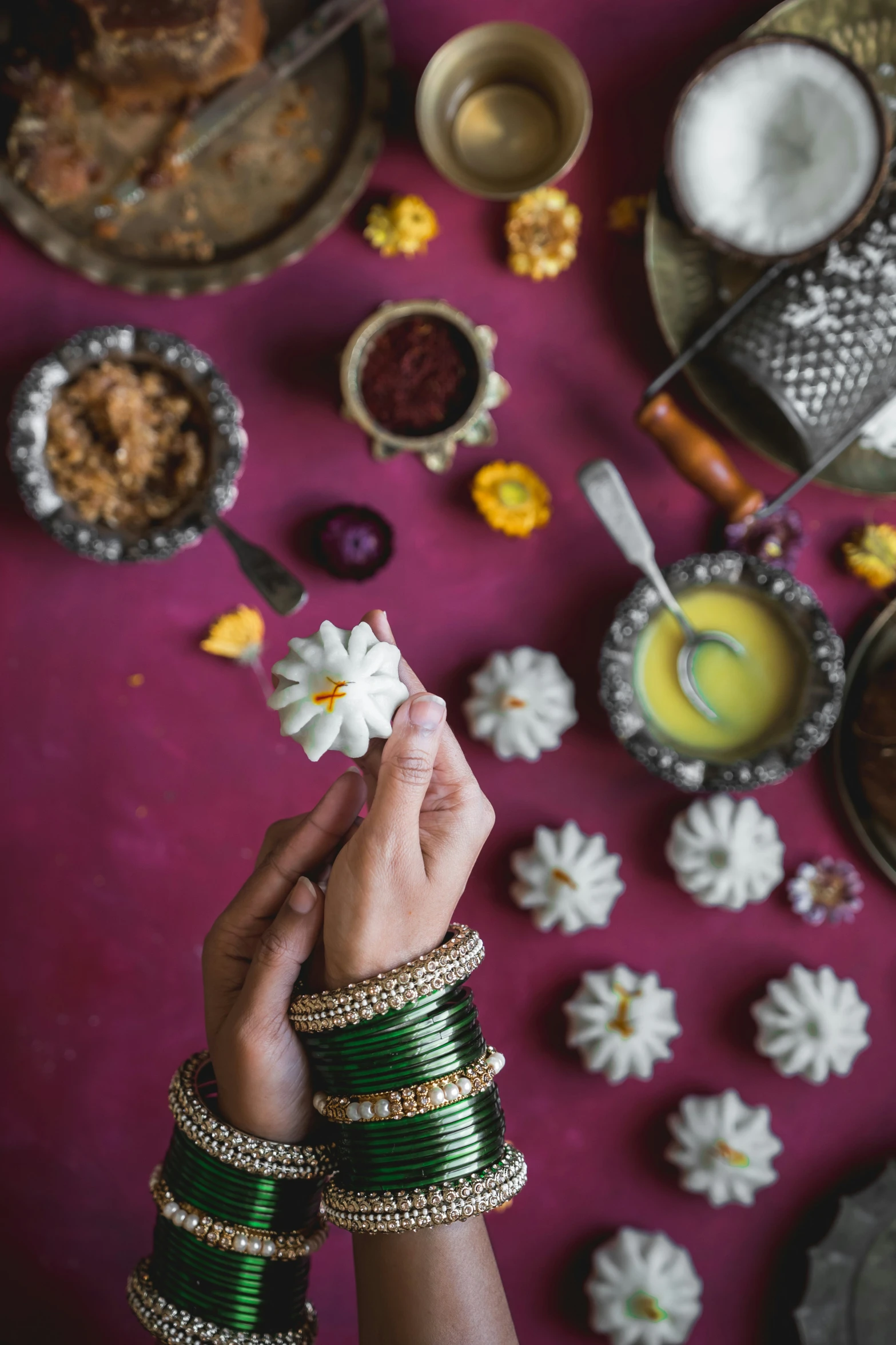 people sitting at a table with food and flowers