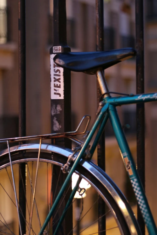 a bicycle leaned against an iron fence