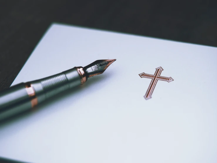 a fountain pen resting on top of a sheet of paper