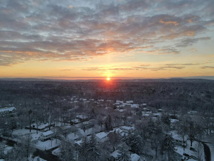 the sun setting in the distance above a city