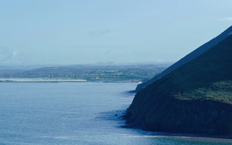 a seagull flying through the air on top of a hill