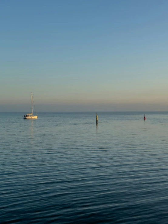 a small boat sailing on top of a body of water