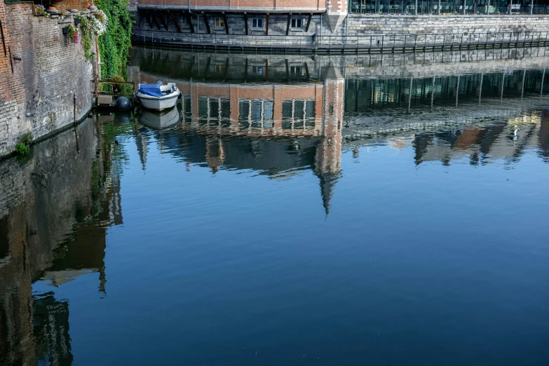 a boat sitting in the water near an old building