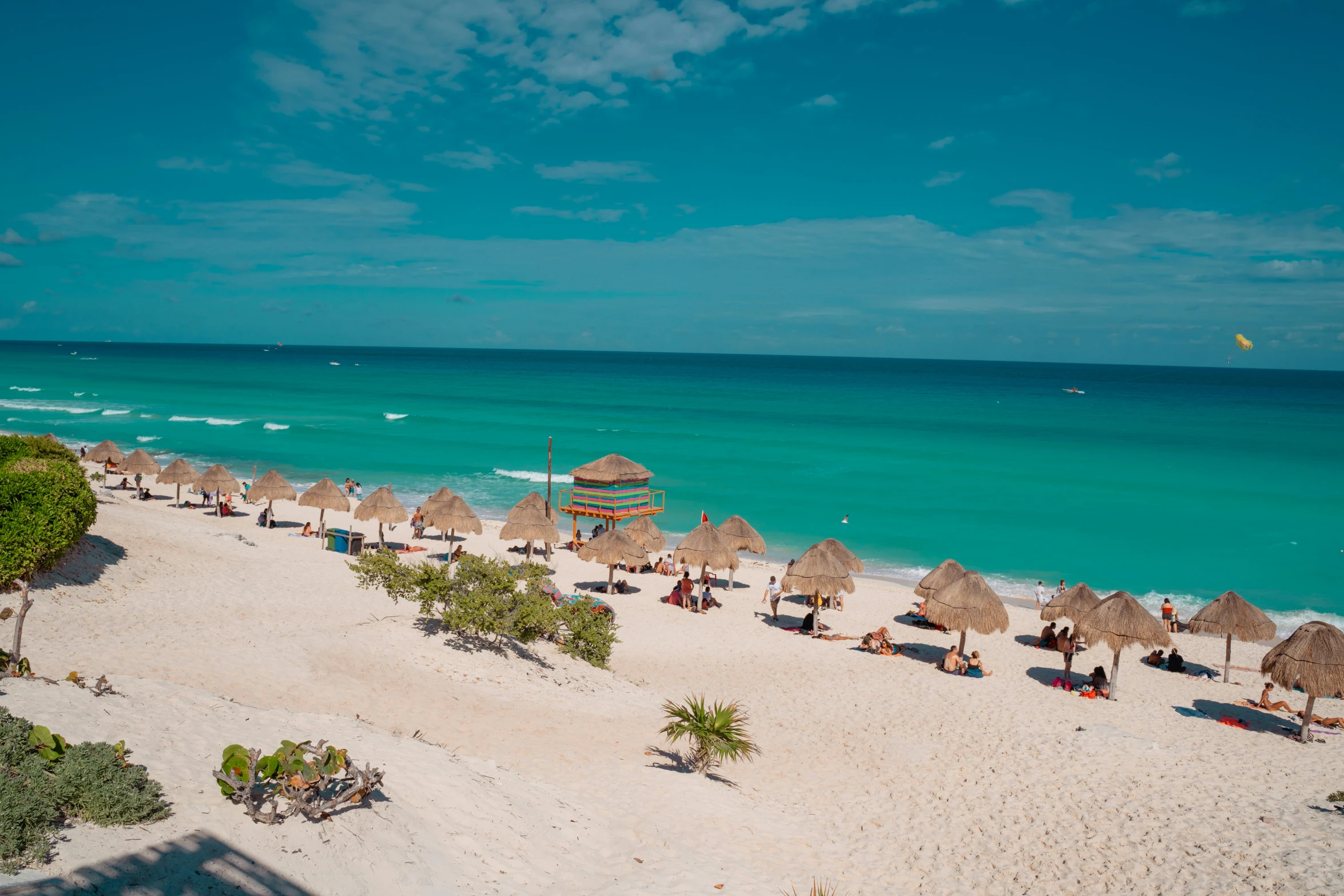 a beach that has chairs and umbrellas on it