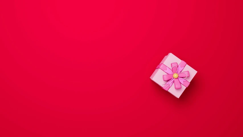 a white box with a pink flower on top of it