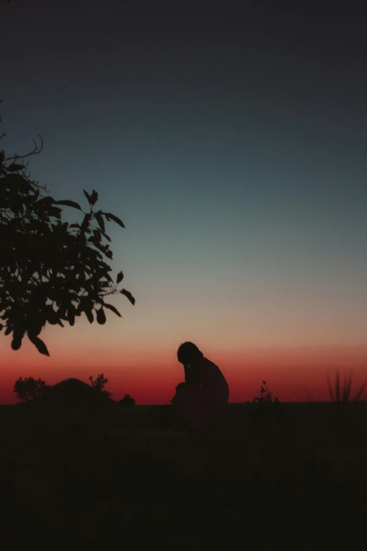 a person that is kneeling in the grass