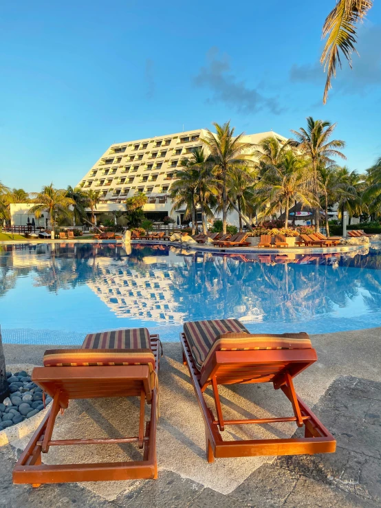 the resort pool has lounge chairs facing it