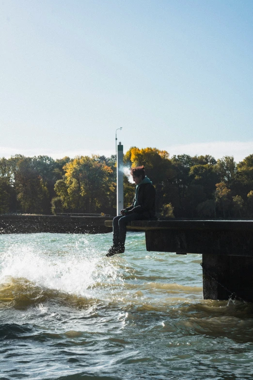 a man in the water with trees in the background