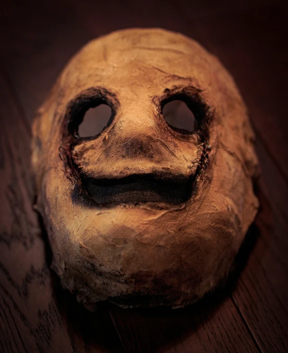 the face of a creepy mask with one eye is seen