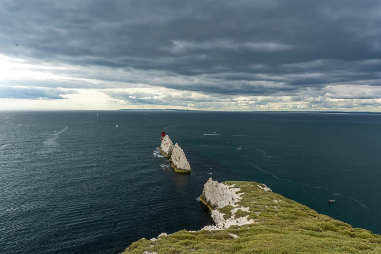 this is the sea and some rocks on a cloudy day