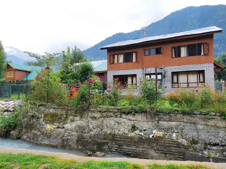 a home with flowers by the side of the road