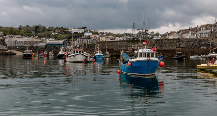 several small boats floating in a body of water