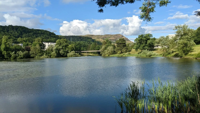 an empty body of water surrounded by wooded areas