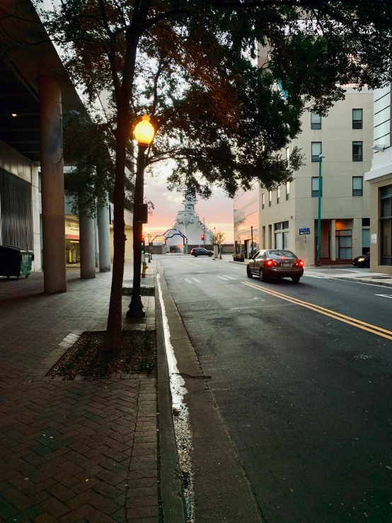 a small city street in the evening with street lights