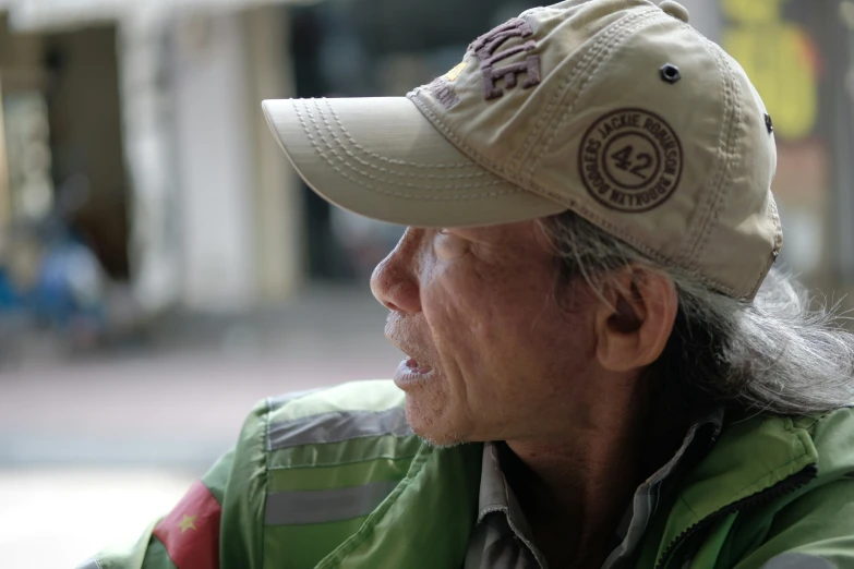 an elderly man sitting in front of a building