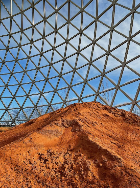 a pile of dirt sitting underneath a metal roof