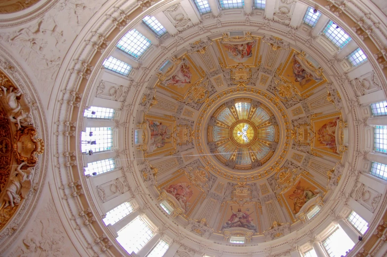 a dome ceiling has a glass pattern and many windows