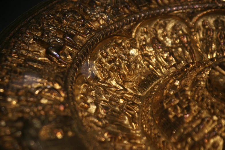 golden plate that has different patterns and sizes on it