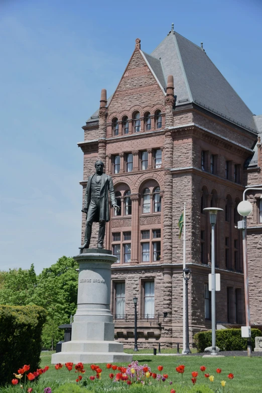 a big building with a statue of a man in front