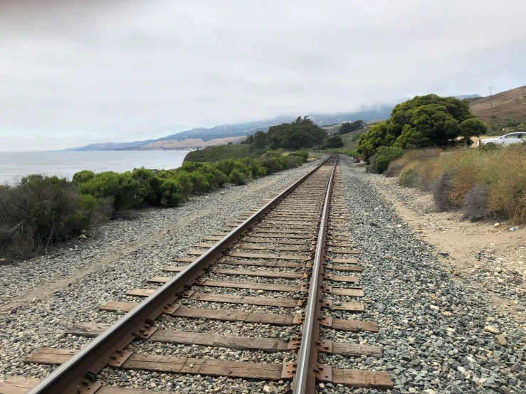 there is a train on the tracks by the beach