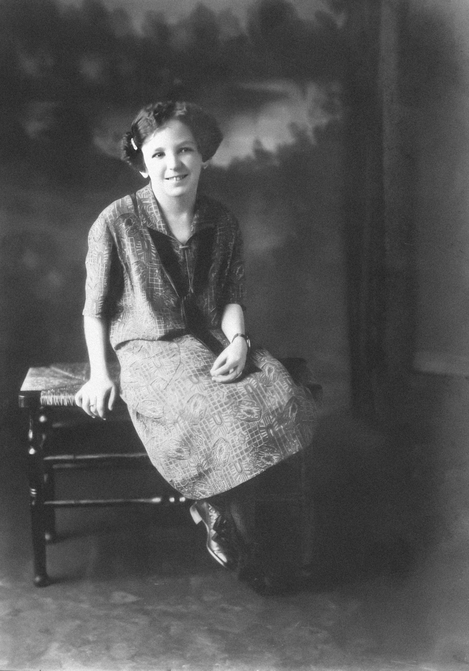 a black and white image of a smiling woman